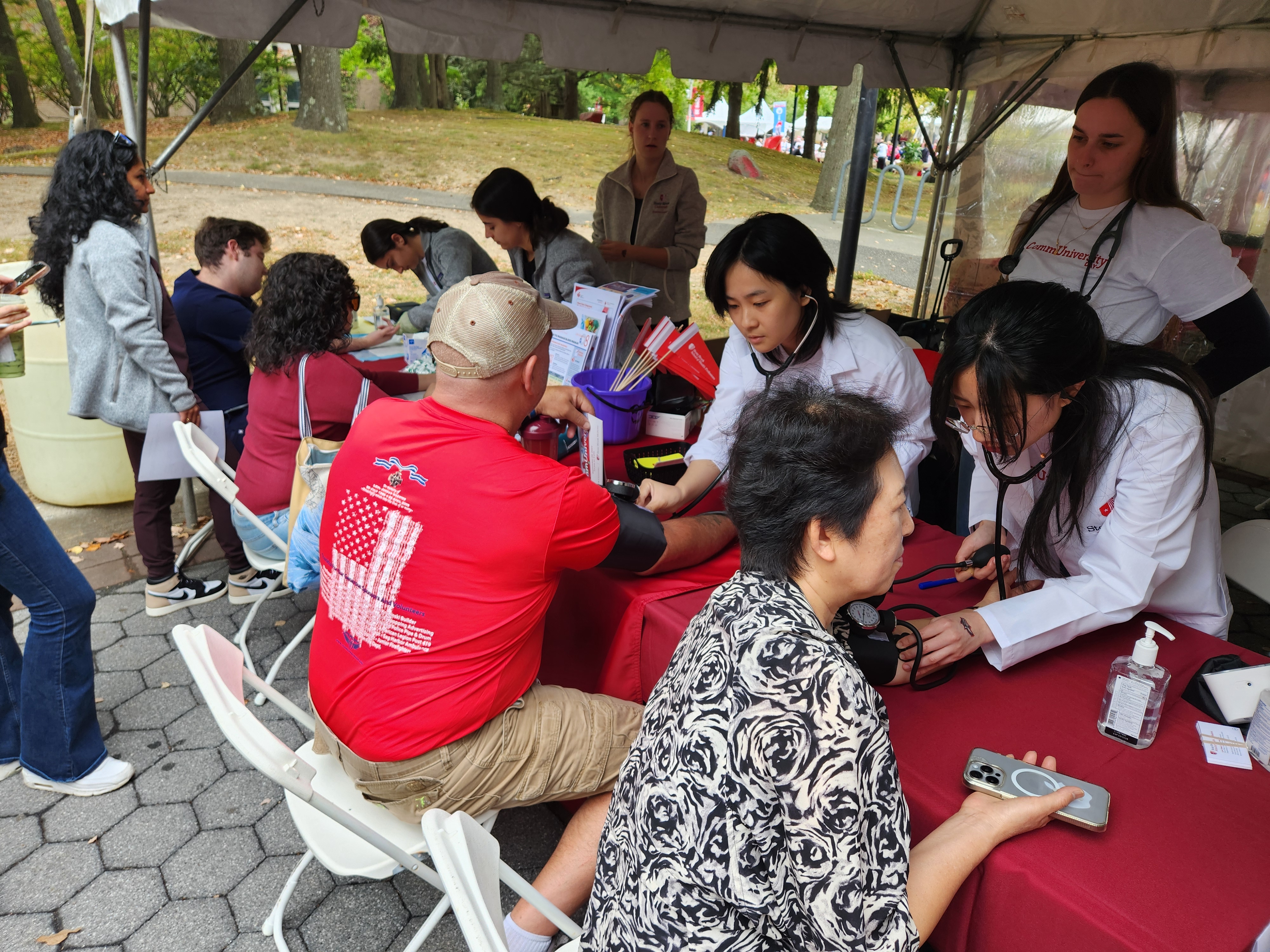 PA students checking blood pressure and cholesterol on people at CommUniversity day 2024