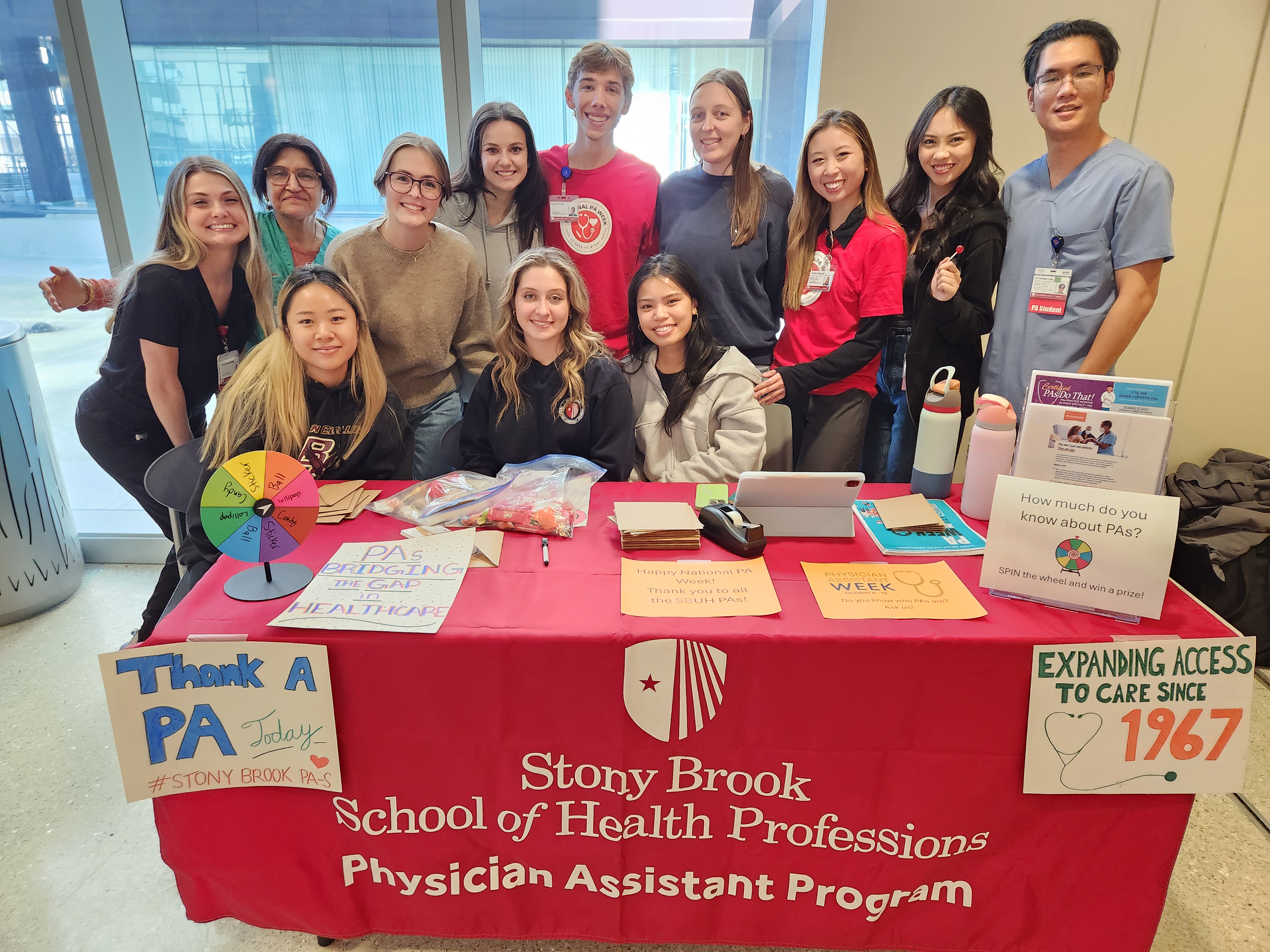 PA CLass of 2026 students around table with University Hospital PAs during PA week