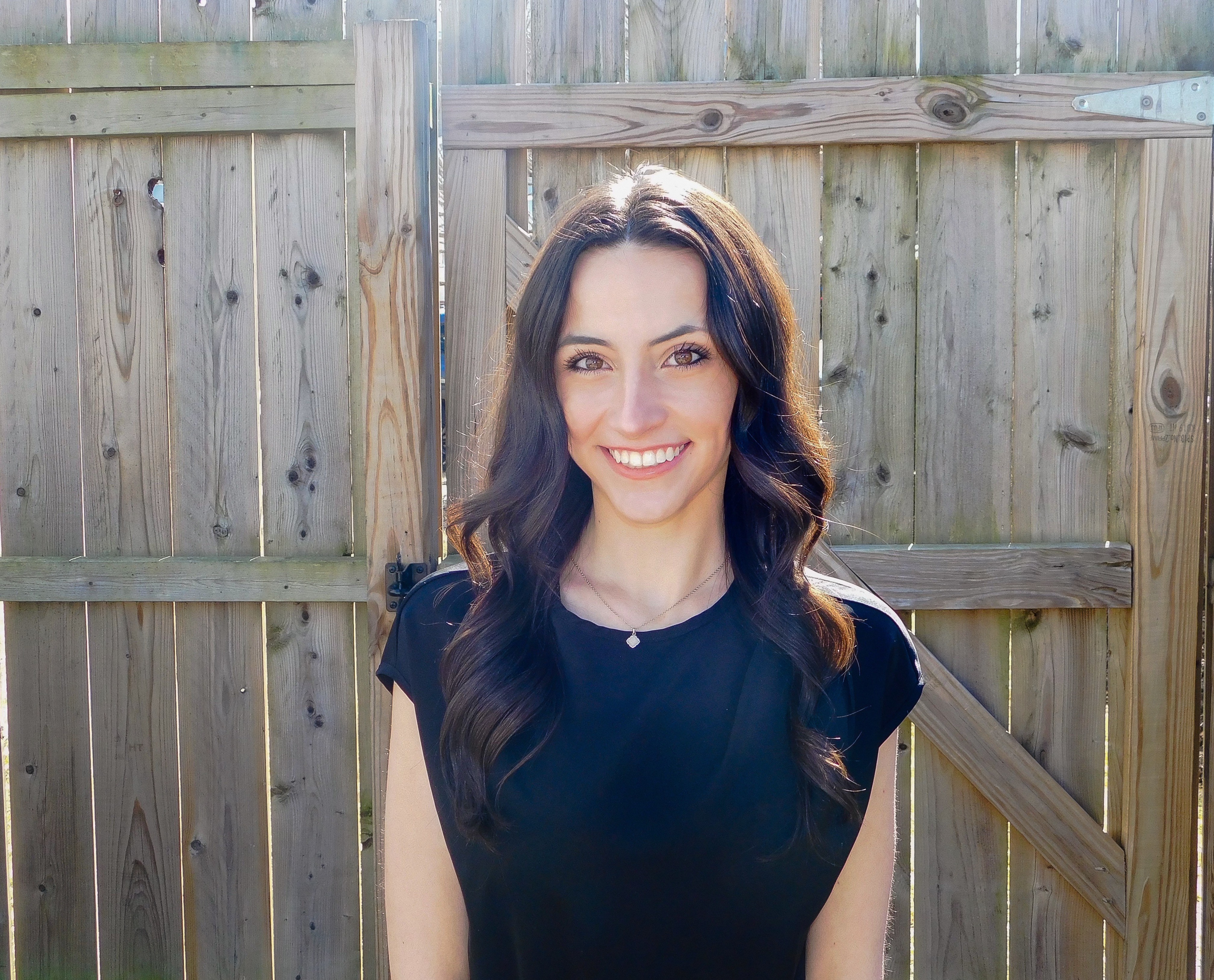 Student Rachel Gmelin standing outside in front of a fence