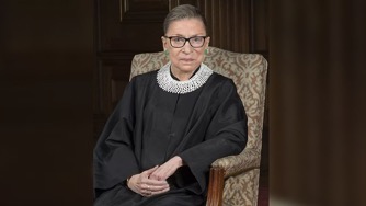 Ruth Bader Ginsberg, seated, in judicial attire