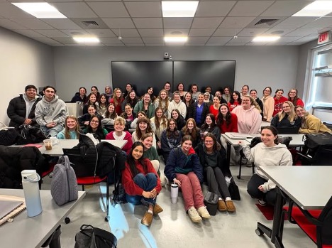 students standing and sitting to pose for a group photo